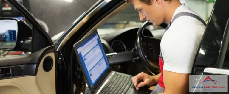 ADAG Blog 18 - Auto serviceman diagnosing a car with his laptop