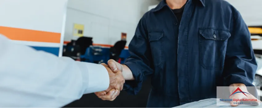 ADAG Blog 24 - An auto mechanic shaking hands with a satisfied client