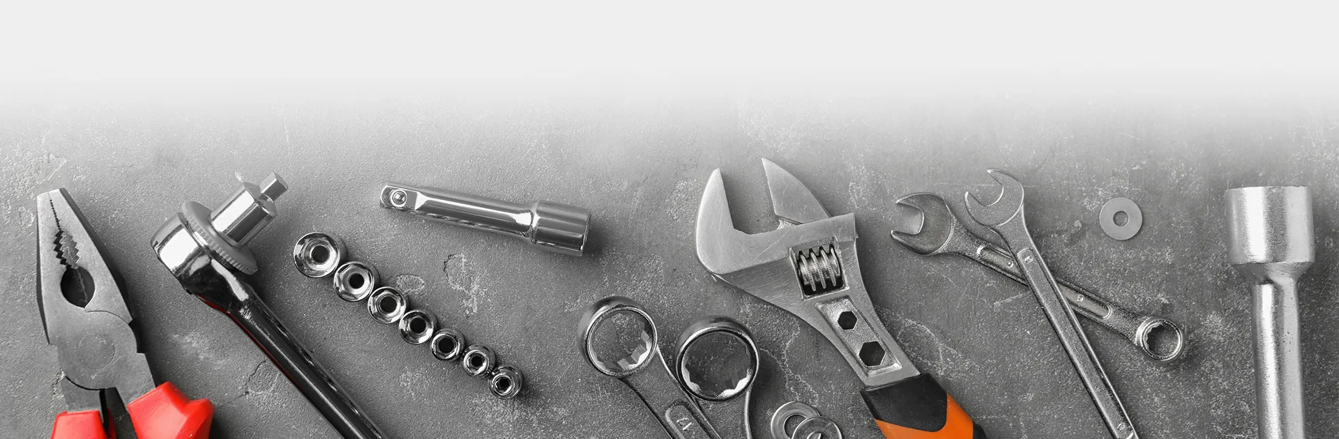 Auto mechanic`s tools on grey stone table.